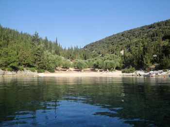 Scenic view of lake and mountains against clear sky