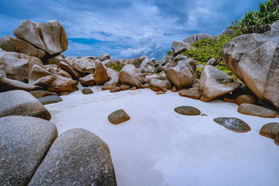 Rocks by sea against sky