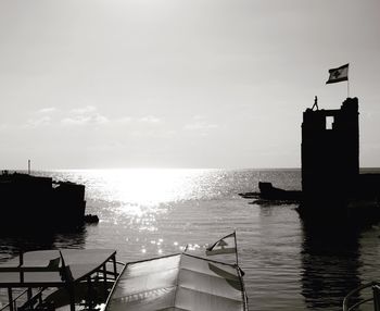 Silhouette pier on sea against sky