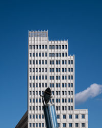 Low angle view of modern buildings against clear blue sky