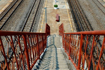 High angle view of footbridge over railroad tracks