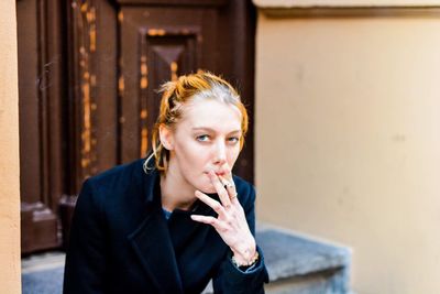 Young woman smoking cigarette