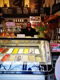 Portrait of man standing by store