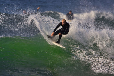 Full length of man surfing in sea