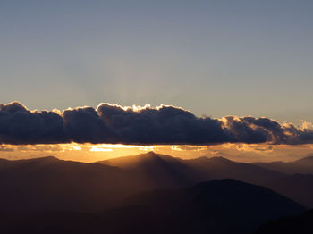 Scenic view of mountains against clear sky during sunset