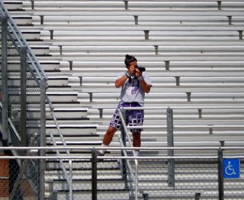 Full length of woman standing on railing