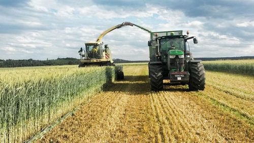 Tractor on agricultural field against sky