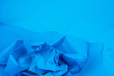 High angle view of blue sea against white background