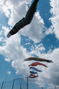 Low angle view of flags hanging against sky