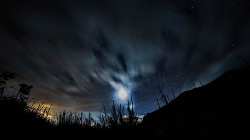 Low angle view of silhouette landscape against sky at night