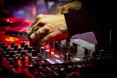 Midsection of man using sound mixer