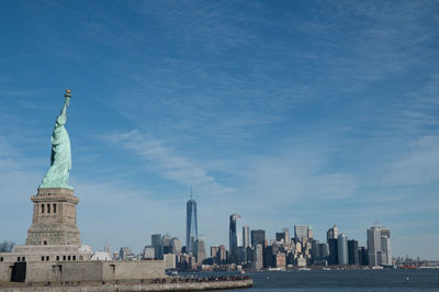 Statue of liberty against sky in city