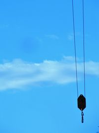 Low angle view of telephone pole against blue sky