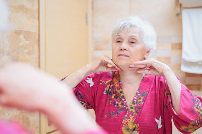 Mature woman taking care of her face