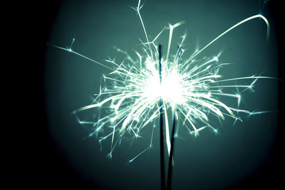 Close-up of illuminated fireworks against sky at night