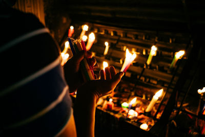 Close-up of lit candles in temple