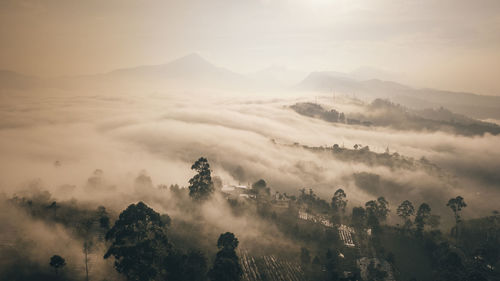 Scenic view of mountains against sky during foggy weather