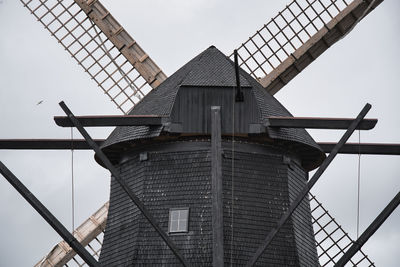 Low angle view of windmill against sky