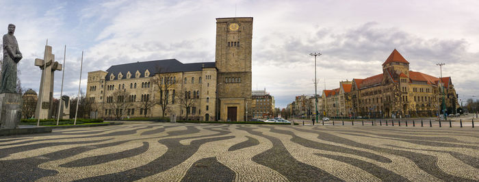 Panoramic view of buildings in city against sky