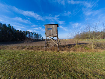 Built structure on field against sky