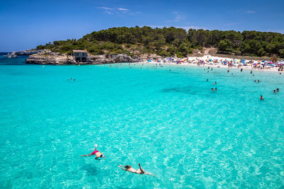 People swimming in sea