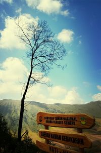 Information sign on landscape against cloudy sky