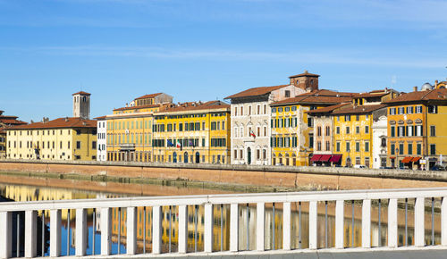 Pisa city centre in italy with buildings reflected in the arno river