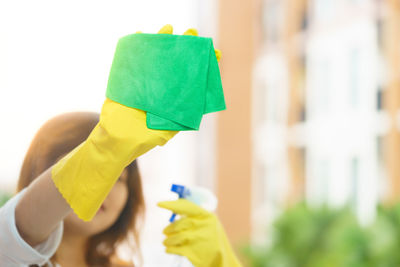 Woman cleaning glass window