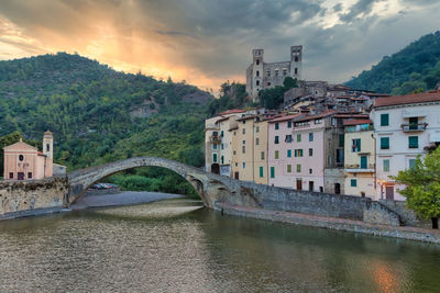 View of bridge over river by buildings