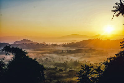 Scenic view of silhouette mountains against sky during sunset