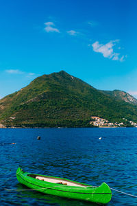 Scenic view of sea and mountains against blue sky