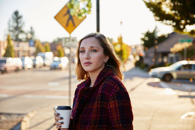 Portrait of young woman holding drink