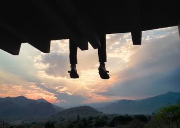 Low section of person sitting roof