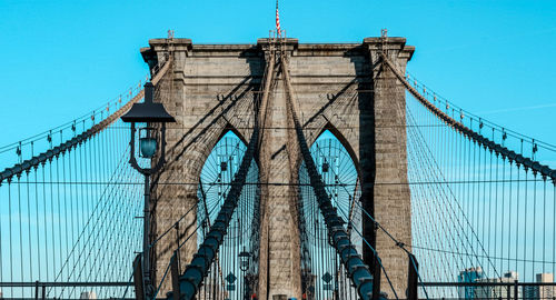 Low angle view of bridge against blue sky