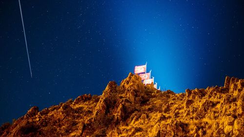 Low angle view of buildings against sky at night