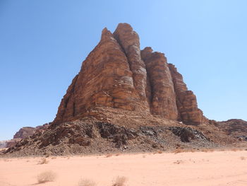 Low angle view of rock formation on land against clear sky