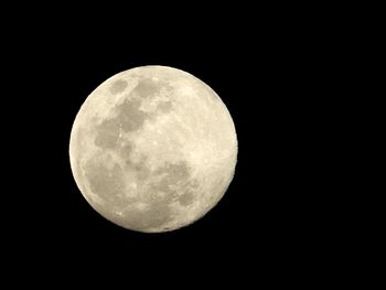 Low angle view of moon against clear sky at night