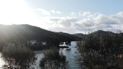 Scenic view of lake against cloudy sky