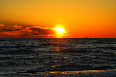 Scenic view of sea against romantic sky at sunset