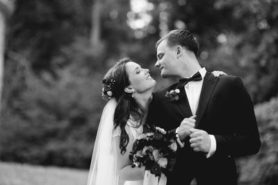 Young couple holding bouquet