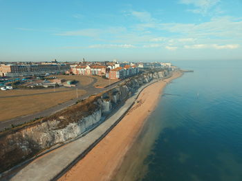 High angle view of sea and buildings against sky