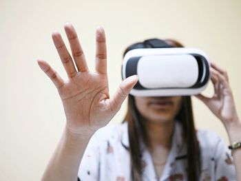 Woman gesturing while using virtual reality simulator