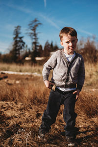 Full length of boy standing on field