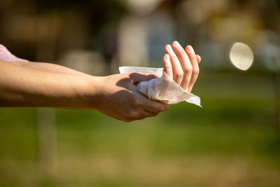 Close-up of hand holding paper