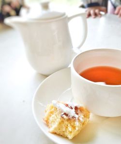 Close-up of tea cup and coffee on table