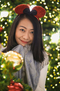 Portrait of smiling young woman holding flower