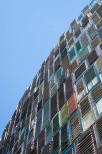 Low angle view of modern building against clear blue sky