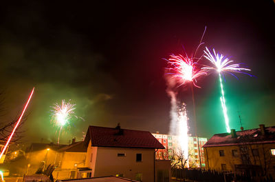 Low angle view of firework display at night