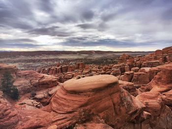 View of rock formations against cloudy sky