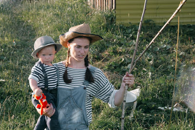 Young mother with a young son on the lake on a fishing trip.